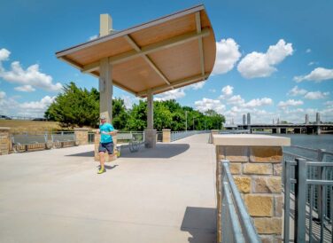 man running on Waco Riverwalk trail